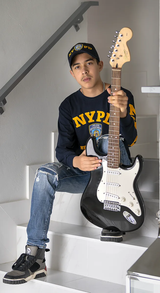Child playing bass guitar